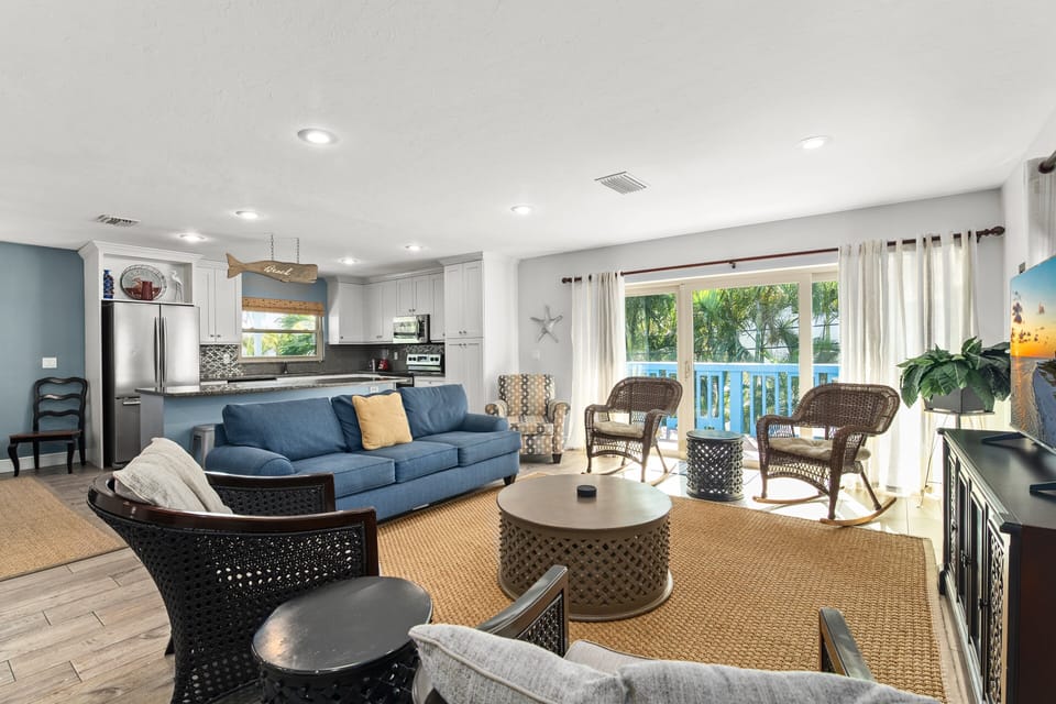 Living Area with Sliding glass doors to balcony and kitchen in background