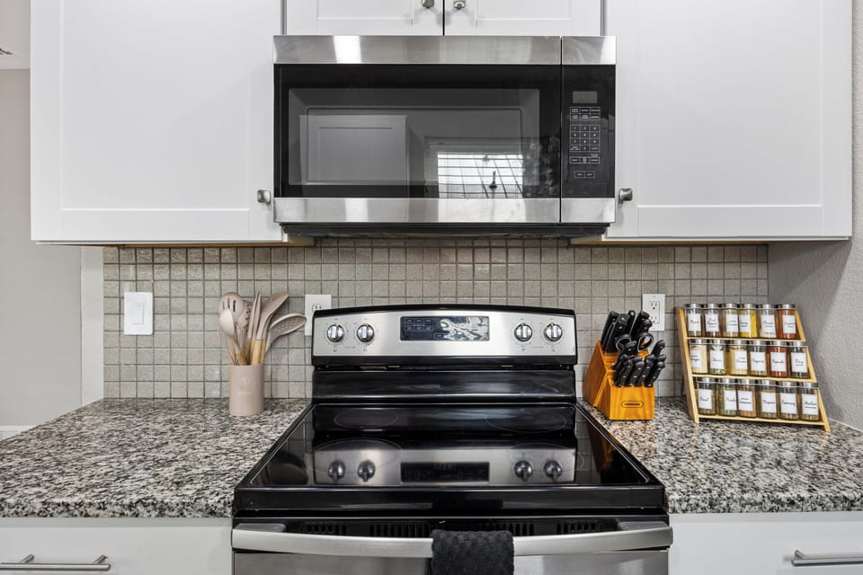 Modern stove, oven, and microwave, plus all essential cookware and utensils
