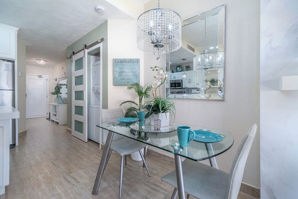 The charming dining table for two has a classy custom drop light.