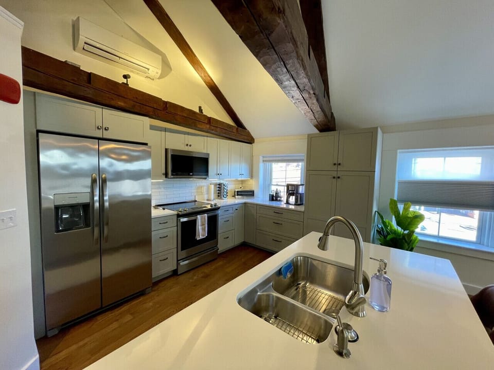 Kitchen with chef knives, single serve and over sizes pots and pans, coffee bar, toaster oven, full spice rack, and crock pot to get cooking