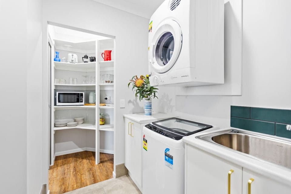 The laundry has a convenient washing machine and dryer, making laundry day a breeze. With ample space for folding and sorting, it’s a practical addition to your stay, offering everything you need for fresh, clean clothes throughout your visit.