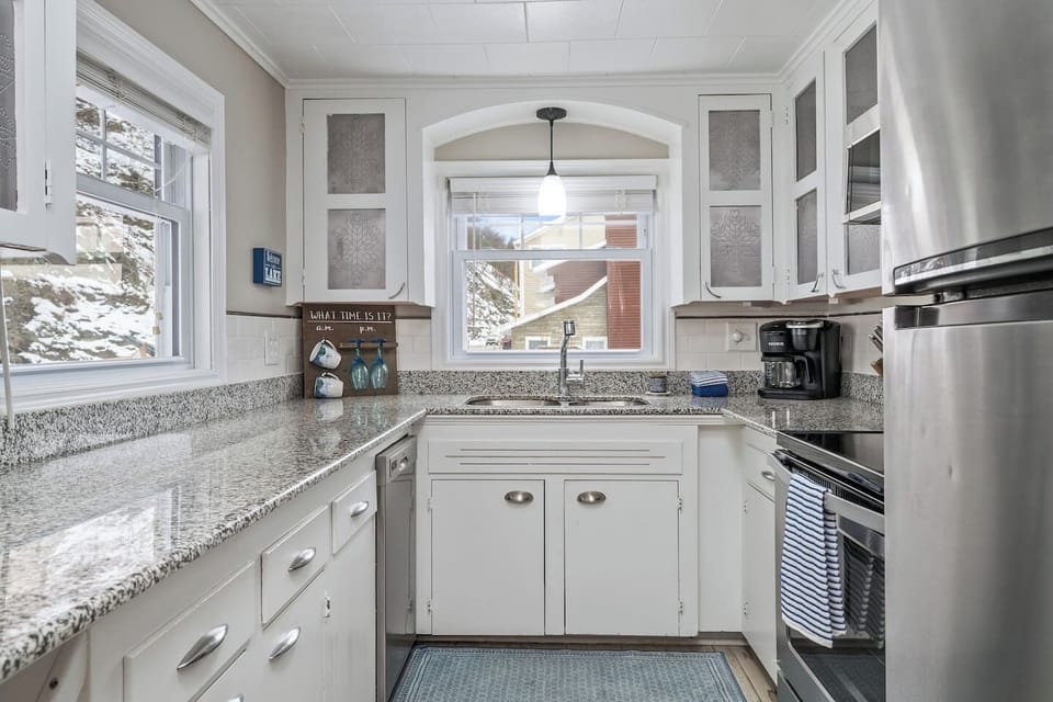 Cook in style with granite countertops, stainless steel appliances, and charming lake house decor.