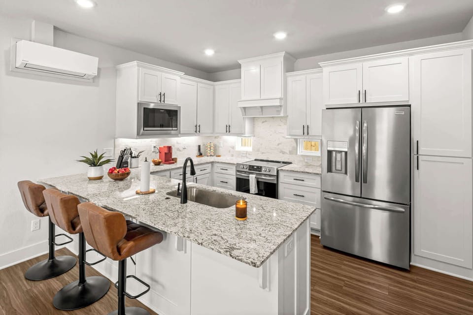 Sleek kitchen with granite countertops, stainless appliances and everything you need to cook at home.