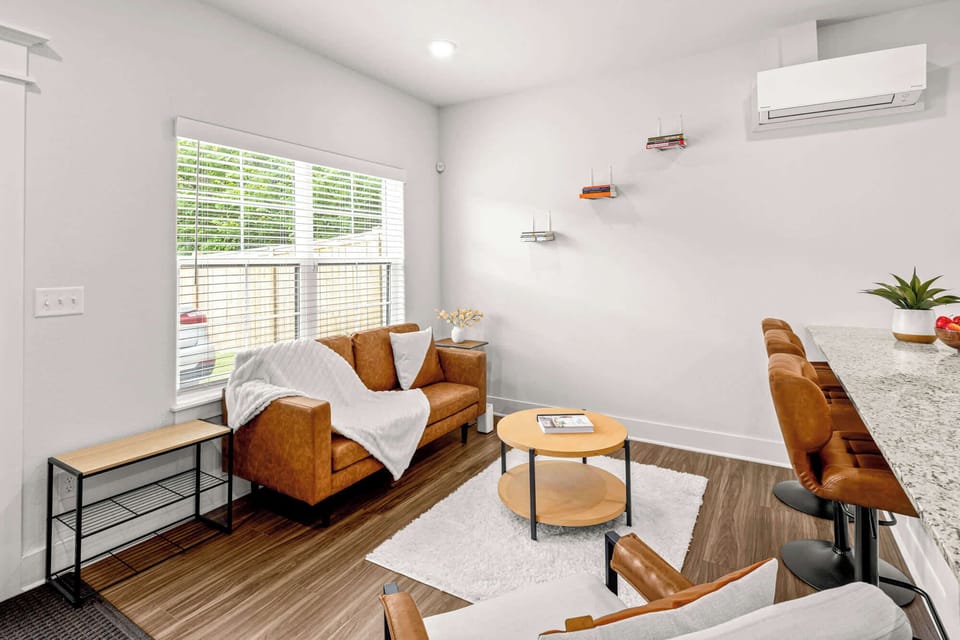Comfortable living room with plush seating and natural light—ideal for unwinding after a game day.