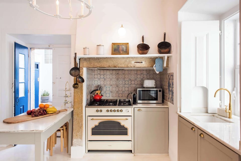Santo Antonio 1 charming kitchen, filled with natural light and vintage details.