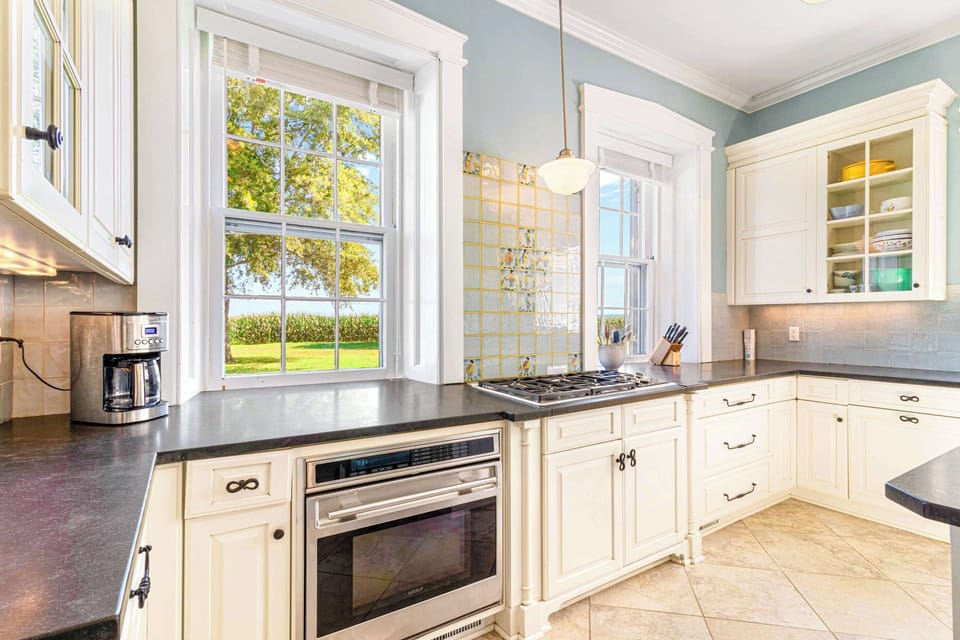 Whip up culinary masterpieces in a chef's dream kitchen, complete with high end appliance and farm and river views.