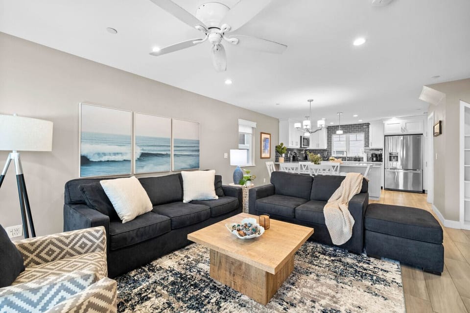 Cozy coastal vibes with comfy seating, ceiling fan, and balcony access. 🌊🛋️