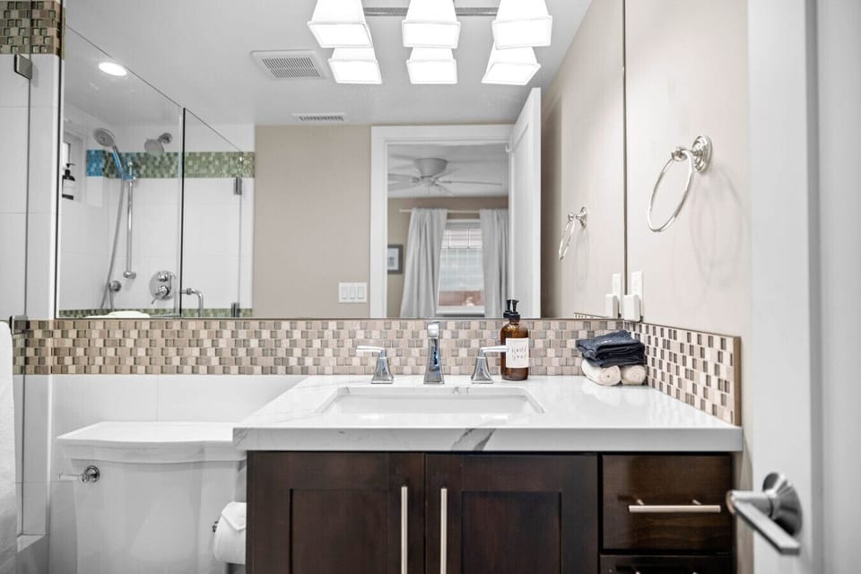 Spa-style shower with dual heads, bench seating, and luxe toiletries. 🚿✨