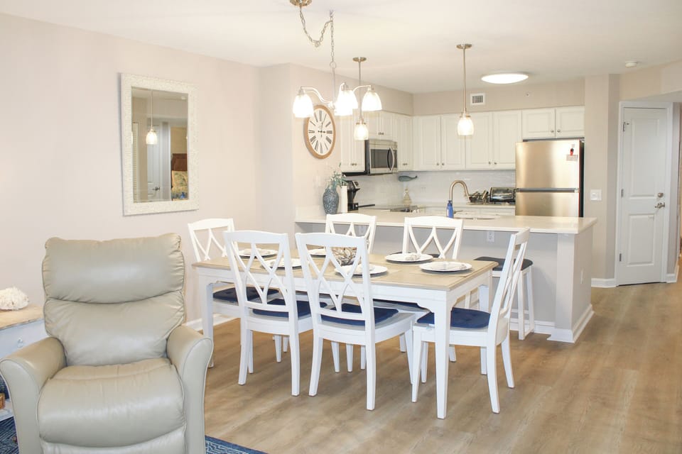 Gather around your spacious dining table for memorable meals, while the fully equipped kitchen awaits your culinary adventures in this bright, welcoming space.