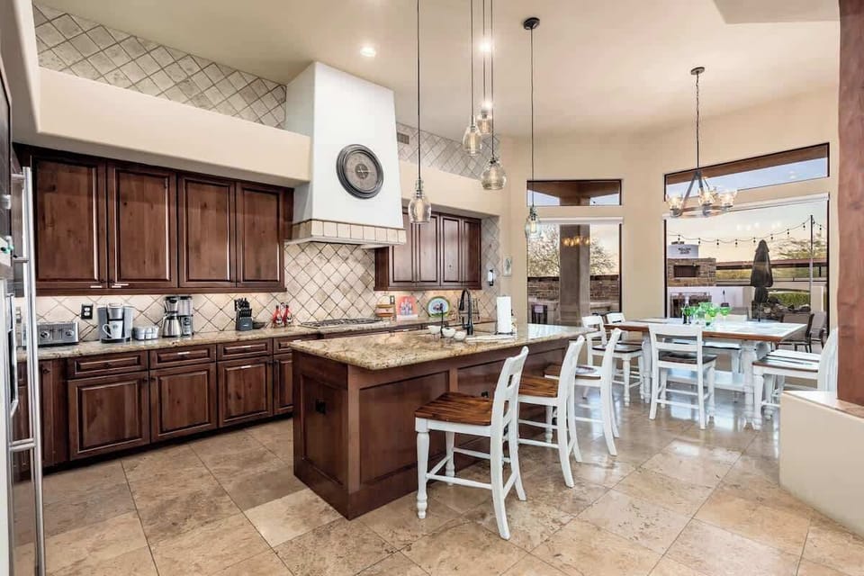 Your spacious kitchen invites culinary adventures with rich wood cabinetry, granite counters, and a center island perfect for morning coffee or meal prep together.