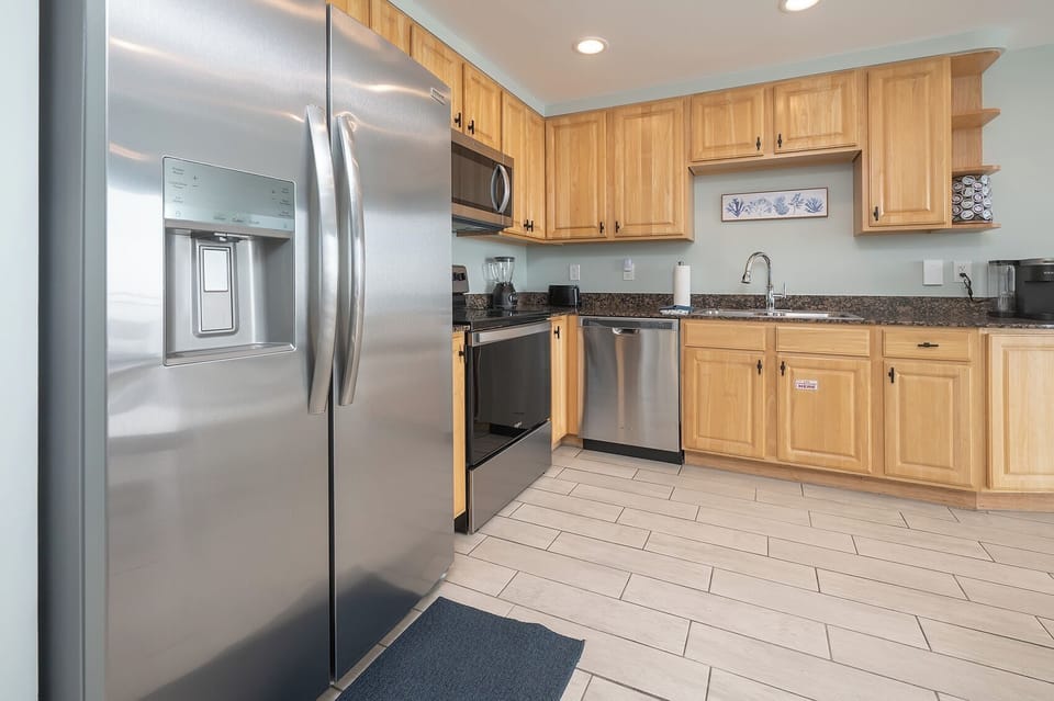 Kitchen featuring all stainless steel appliances, blender and Keurig