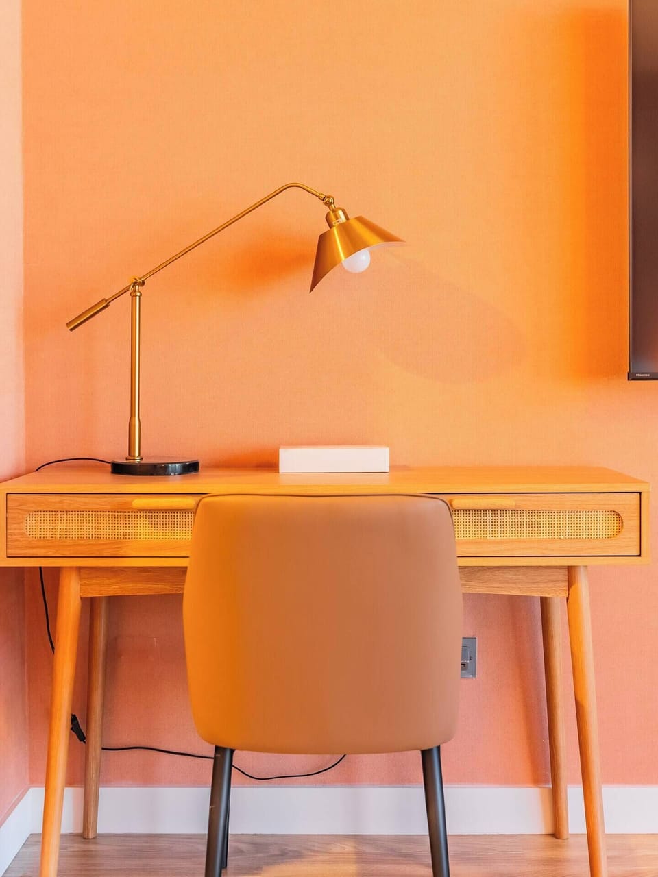 A sleek office desk complemented by a stylish lamp, creating a perfect spot for focused work.