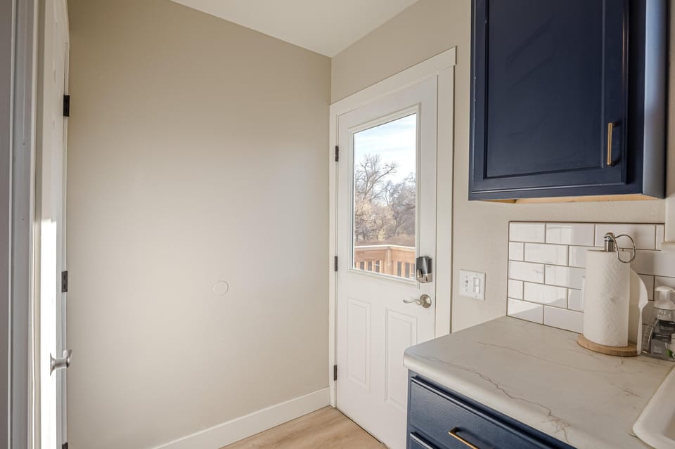 Easily access the beautiful backyard space through the separate kitchen entrance.