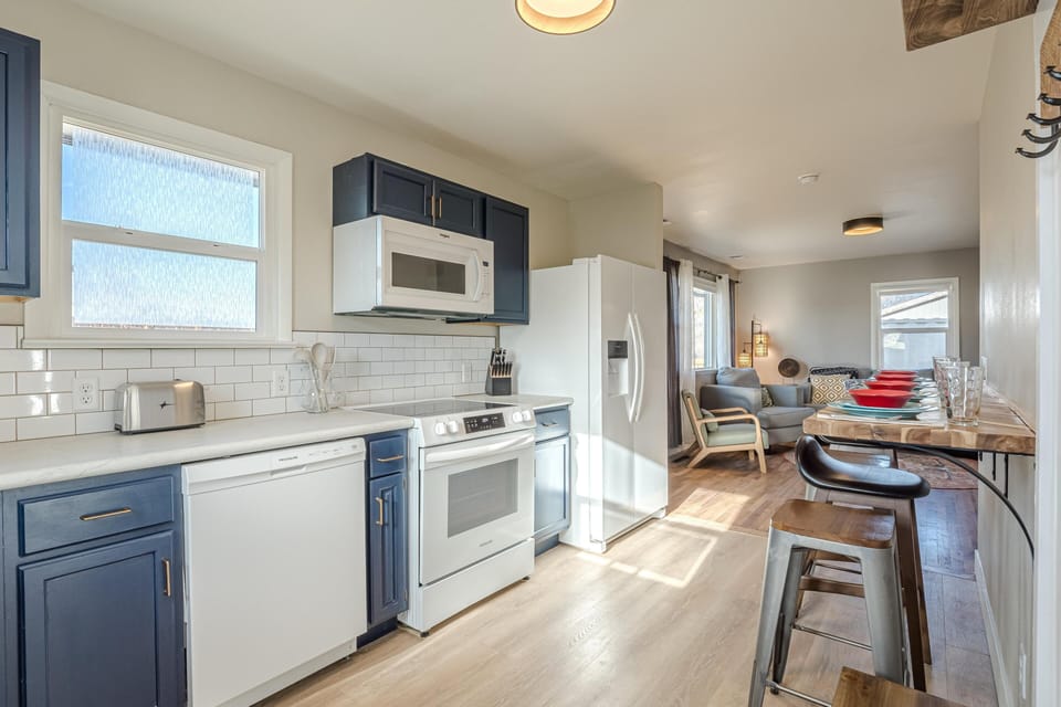 Flooded with natural light, this inviting culinary haven features chic barstool seating, perfect for morning coffee, casual bites, or gathering with friends!