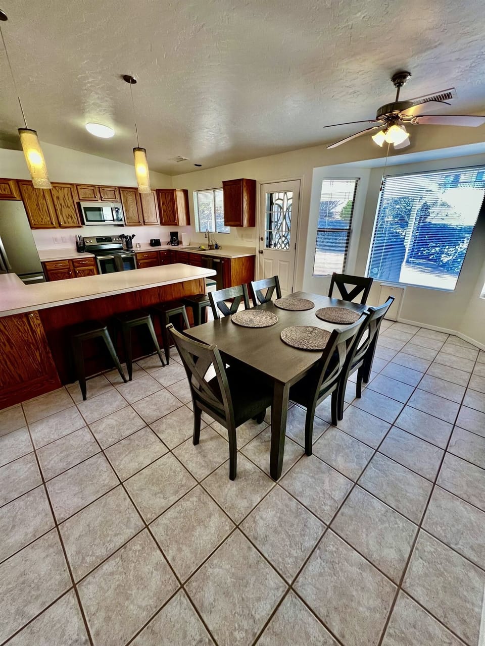 The spacious kitchen boasts ample counter space, stainless steel appliances, and all the essentials you need to whip up a gourmet meal with ease.