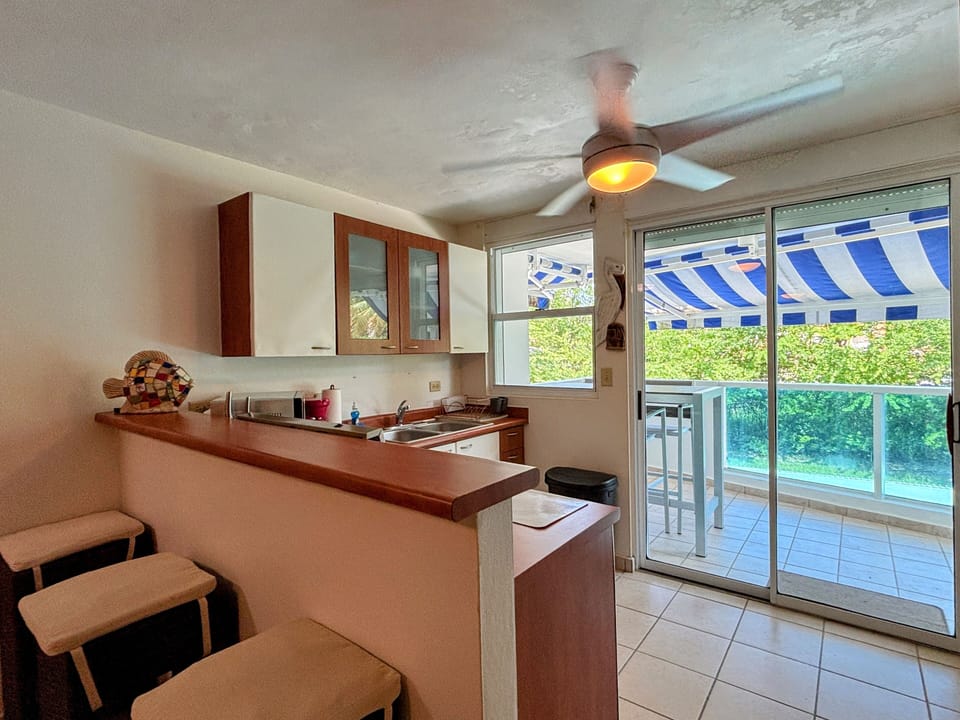 Bright kitchen opens to balcony