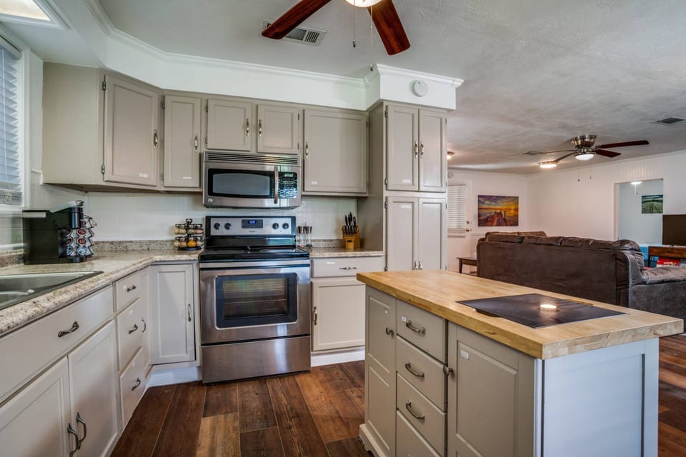 Spacious laundry room with two additional bunk beds, attached bathroom, and a private door, offering comfort and privacy in a cozy, functional space