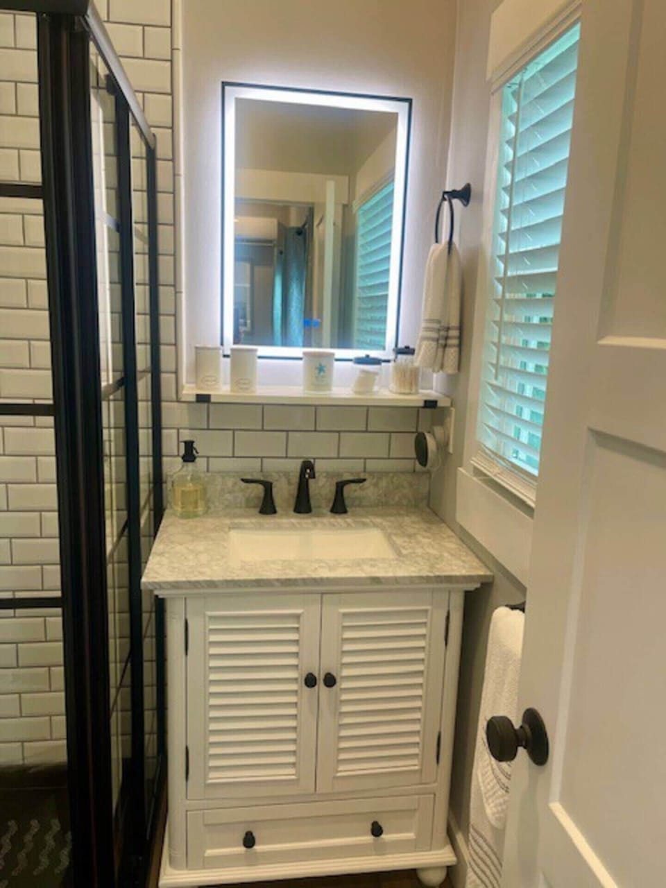Exciting features like a Google mini and lighted mirror make this bathroom functional and fun