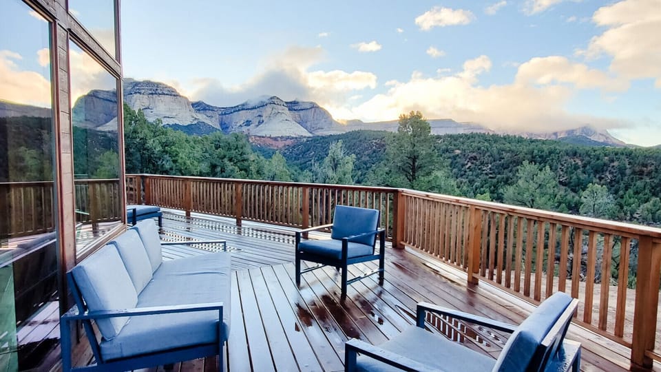 Scenic deck with comfortable seating and panoramic views of majestic mountains and lush forests