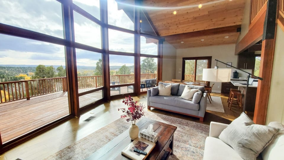 Bright and inviting living space with floor-to-ceiling windows and breathtaking views