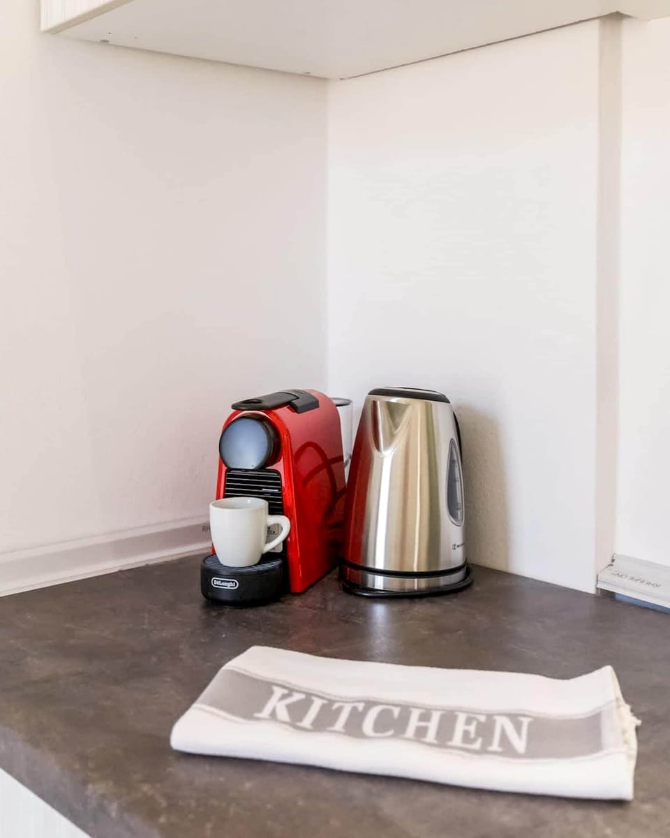 Coffee Station – Practical and Accessible
Nespresso machine and cups for daily caffeine comfort.