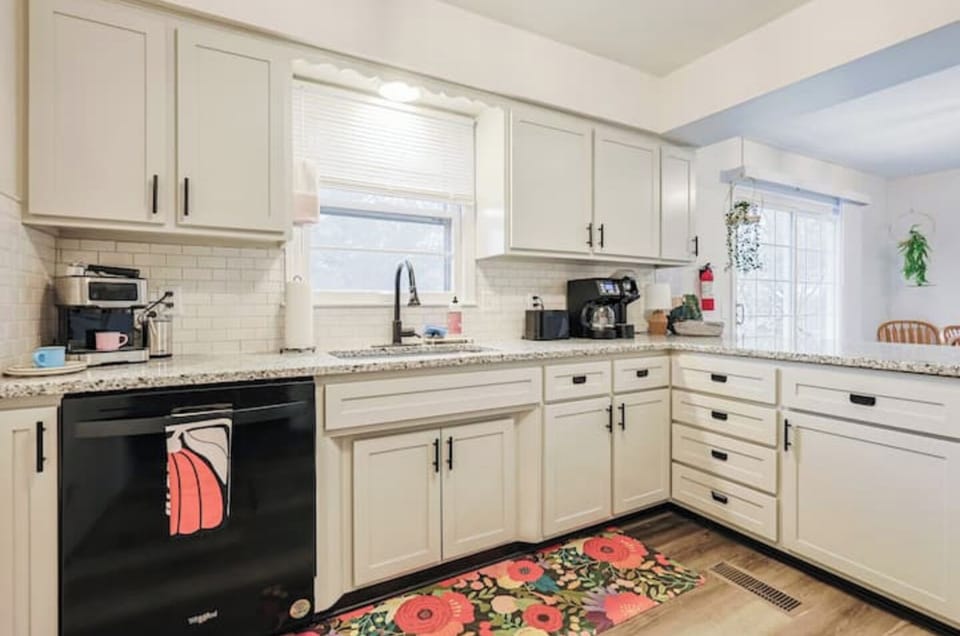 Fully stocked kitchen with modern appliances and cookware