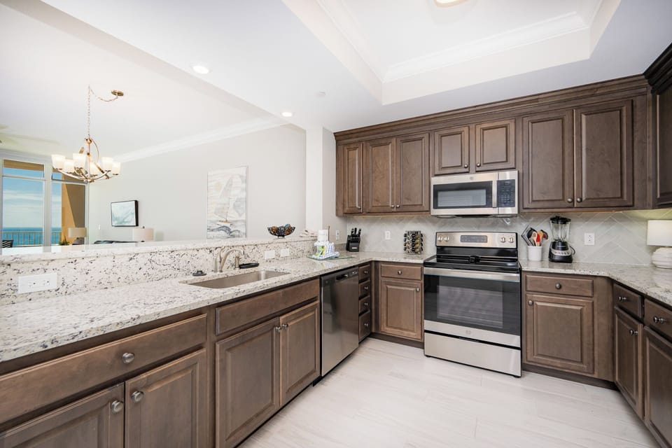 Prepare meals in this kitchen with elegant cabinetry, stainless appliances, and spacious countertops