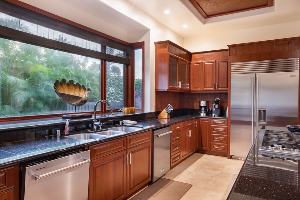 Gourmet kitchen with island seating, wine fridge, and high-end appliances—cook, gather, and enjoy together.