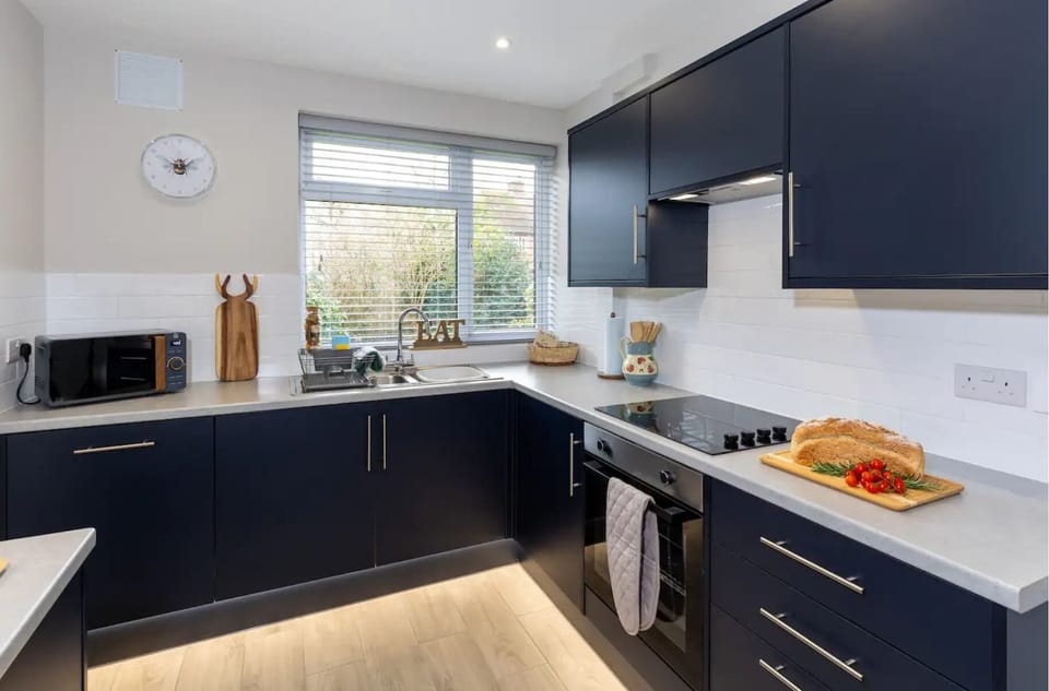 Large kitchen with oven, kettle, toaster and dishwasher