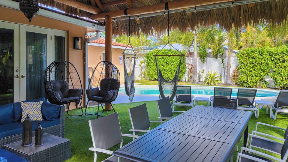 tiki with dining table for 8 people, hummock swings, sectional couch