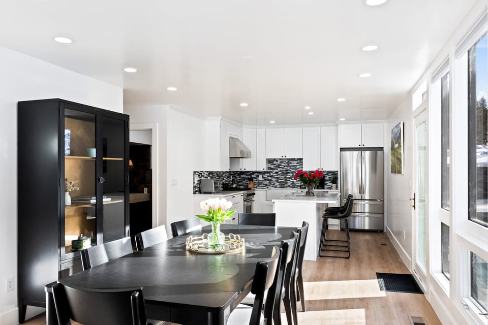 - Modern kitchen with stainless steel appliances and bright cabinetry  
- Dining table for shared meals with mountain views nearby  
- Sleek backsplash and island perfect for cooking and gathering