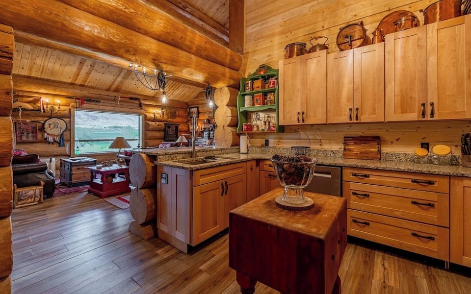 Full custom kitchen with modern appliances and unique antique furnishings.