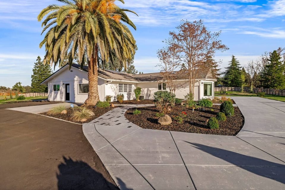 Modern elegance meets spacious living! Explore this stunning single-story home with a sleek concrete driveway, lush landscaping, and timeless charm. Your dream home awaits!