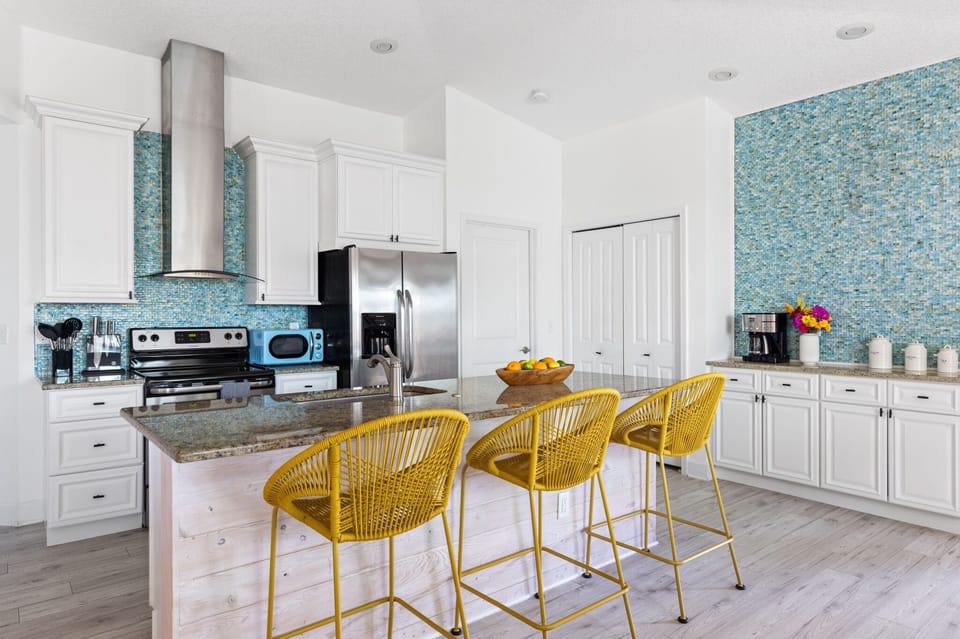 Fully stocked kitchen with barstool seating.