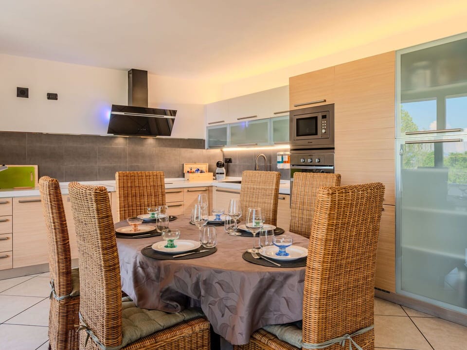 Furniture, Interior Design, Flooring, Floor, Kitchen, Wood, Countertop, Ceiling, Chair, Lighting