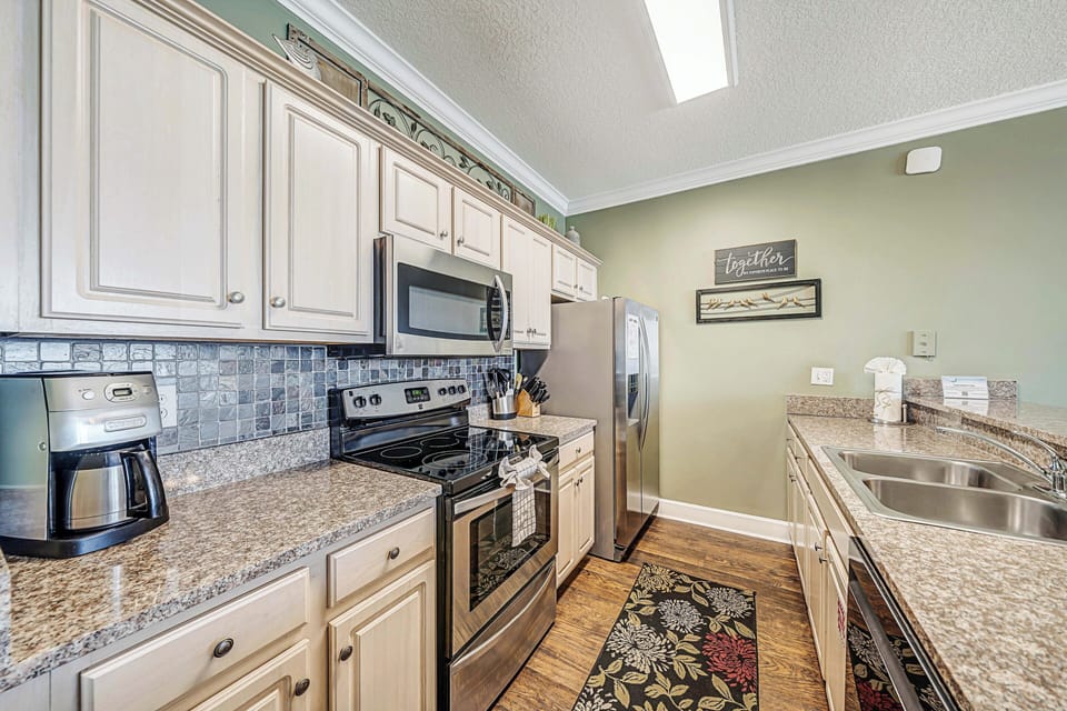 The fully equipped kitchen features granite countertops, stainless-steel appliances, and has everything you need to prepare meals for family & friends.