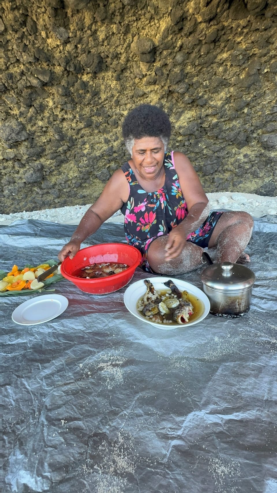 Serving freshly caught fish  cooked in open fire when going to the picnic island