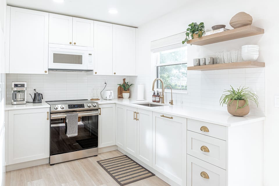 Bright kitchen stocked with; coffee, rice cooker, Filtered water faucet, etc