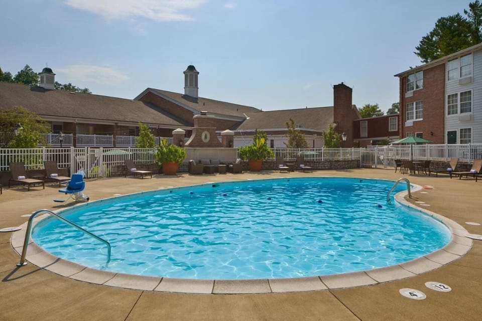 Dive into a refreshing swim in the sunny outdoor pool.