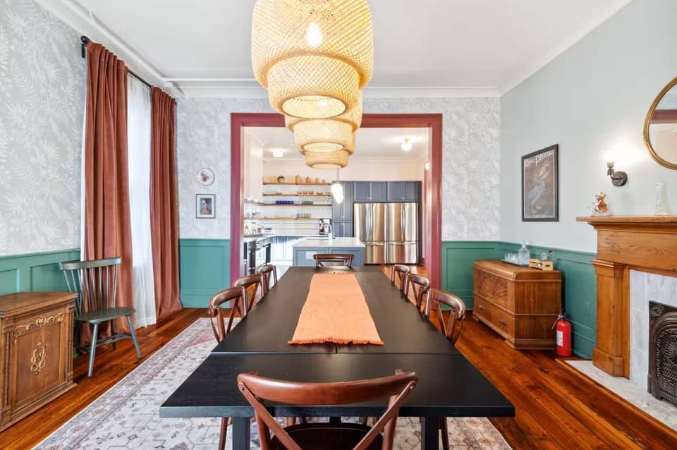 Stylish dining room with a long farmhouse-style table, warm accents, and space to gather comfortably.