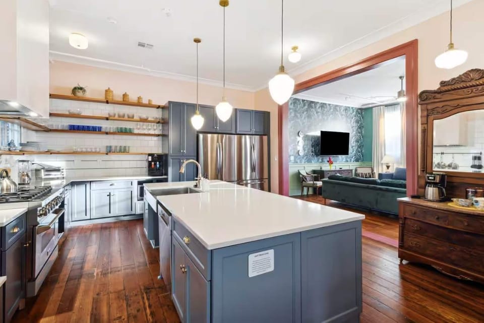 Expansive kitchen featuring a full set of appliances, bar seating at the island counter, and all the cookware, dishes, and utensils you could need. (Ground floor unit)