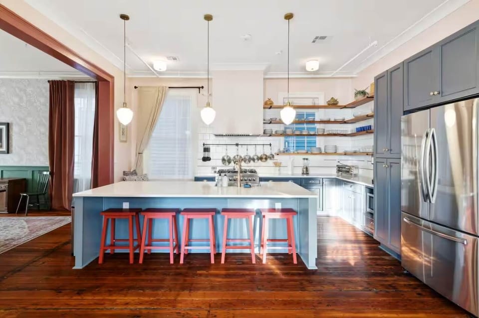 Expansive kitchen featuring a full set of appliances, bar seating at the island counter, and all the cookware, dishes, and utensils you could need. (Ground floor unit)