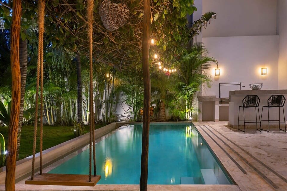 Delicate lighting over the pool and patio.