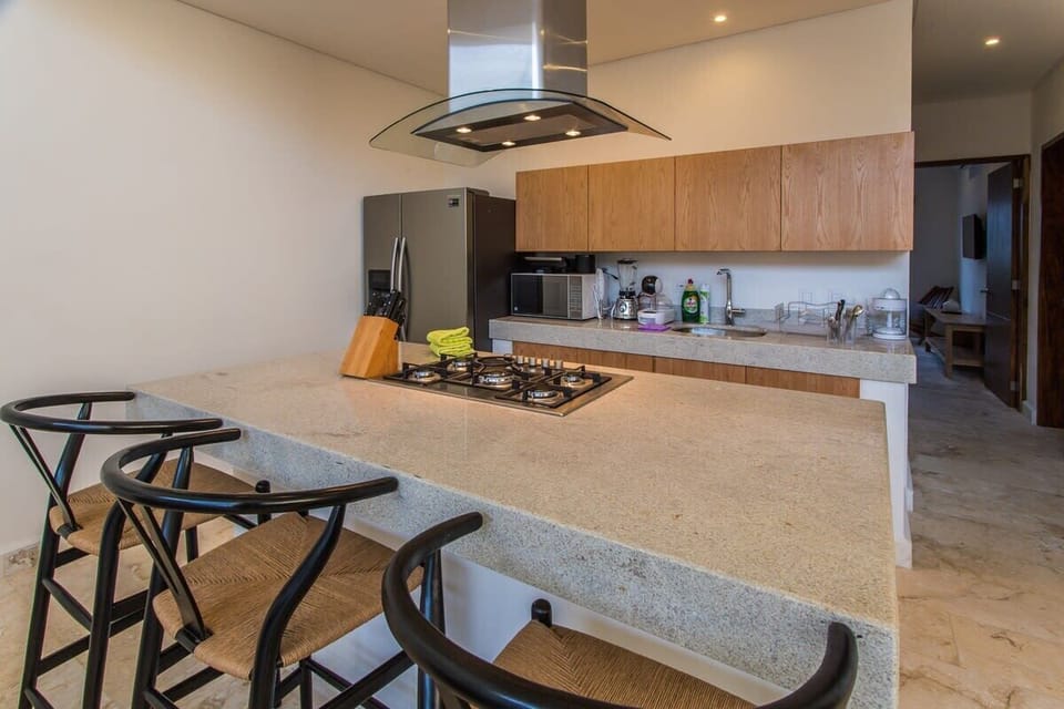 Modern island with an oven and space for three guests.