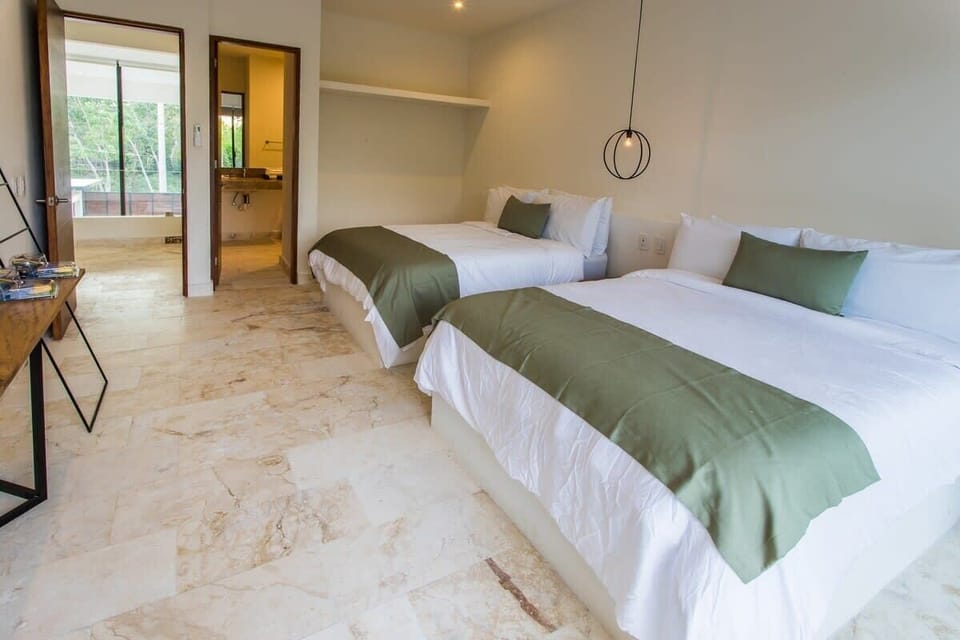 Comfortable room with two double beds. Attached bathroom.