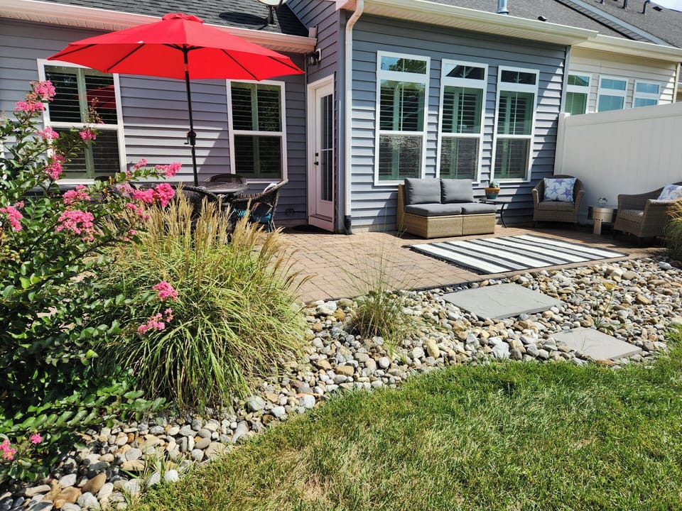 Patio with couch, dining table, grill and chairs
