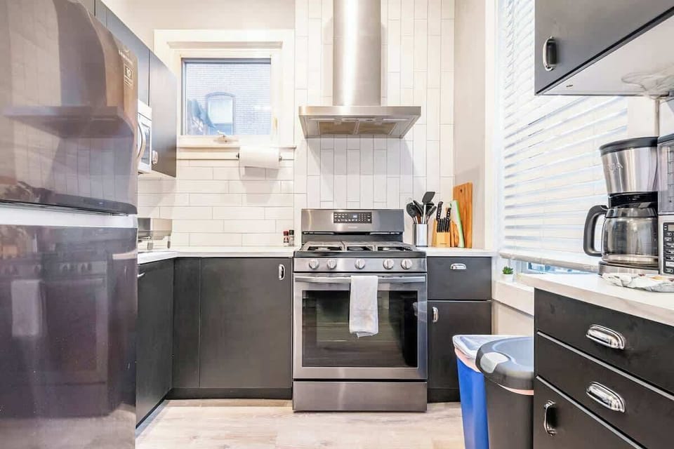 Gas cooking! With stainless steel vent hood and subway tile. Enjoy built in microwave, coffee maker, blender, toaster, and everything you could need in our fully stocked kitchen. 