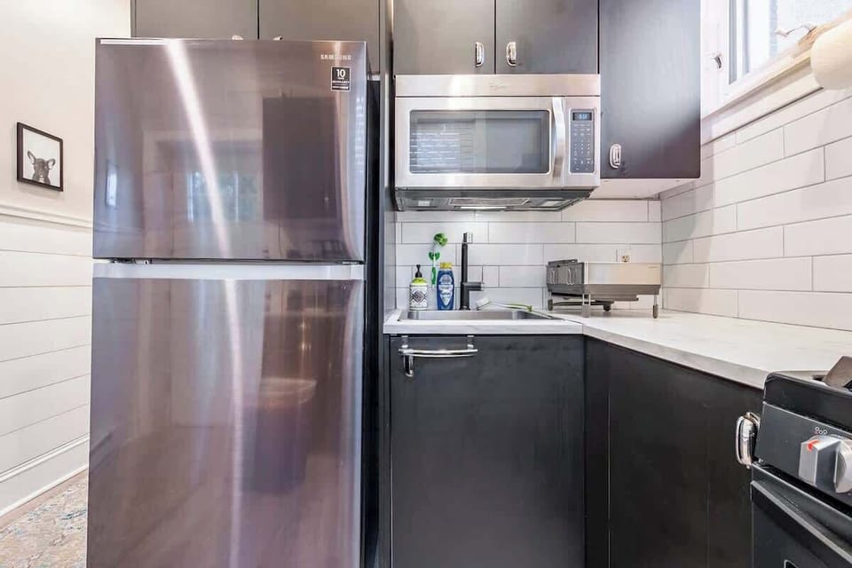 Black and white kitchen with marble styled countertops. 