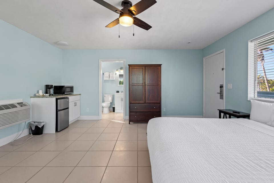 Large spacious room on the 2nd Floor of the Cove Building, features private balcony with a partial ocean view.