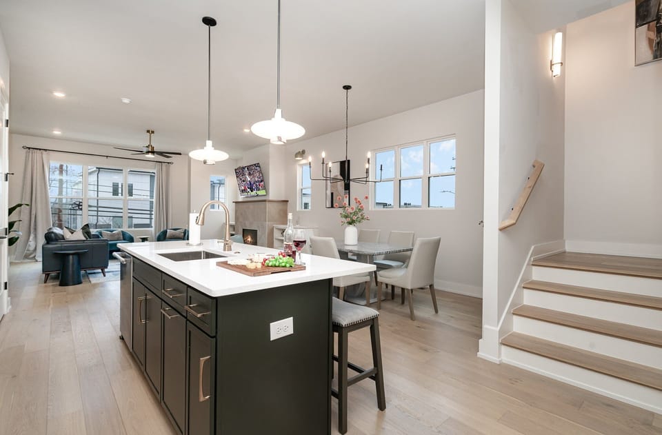 The fully open floor-equipped modern kitchen is stocked with all culinary essentials, stainless steel appliances, a wine fridge, and breakfast bar seating. (2nd Floor)